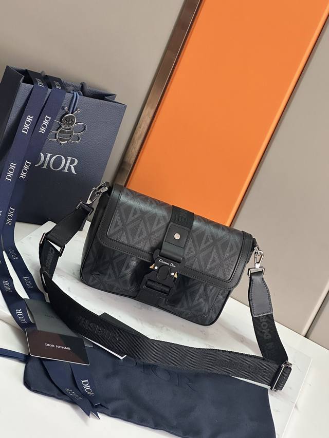 顶级原单 这款 Dior Hit The Road 手袋搭配肩带，是本季新品，将现代风格与 Dior 的高订精神融为一体。采用灰色 Cd Diamond 图案帆